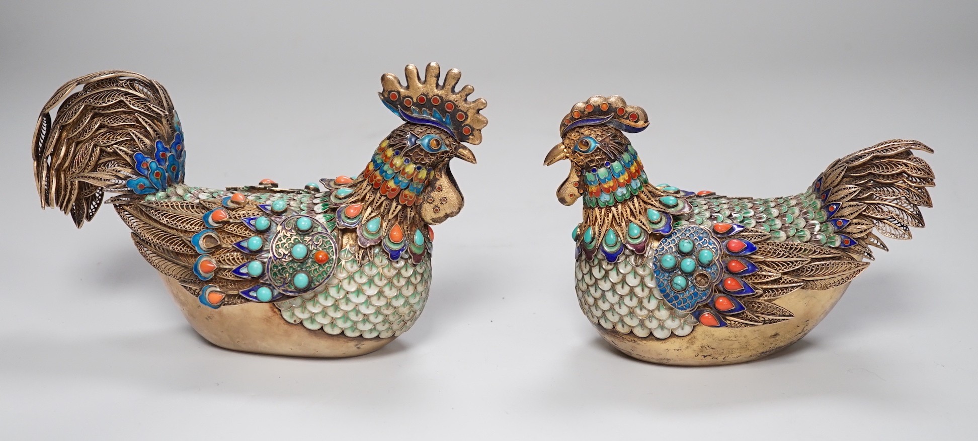 A pair of cased Chinese enamelled gilt white metal roosters with turquoise and coral mounts 14cms wide